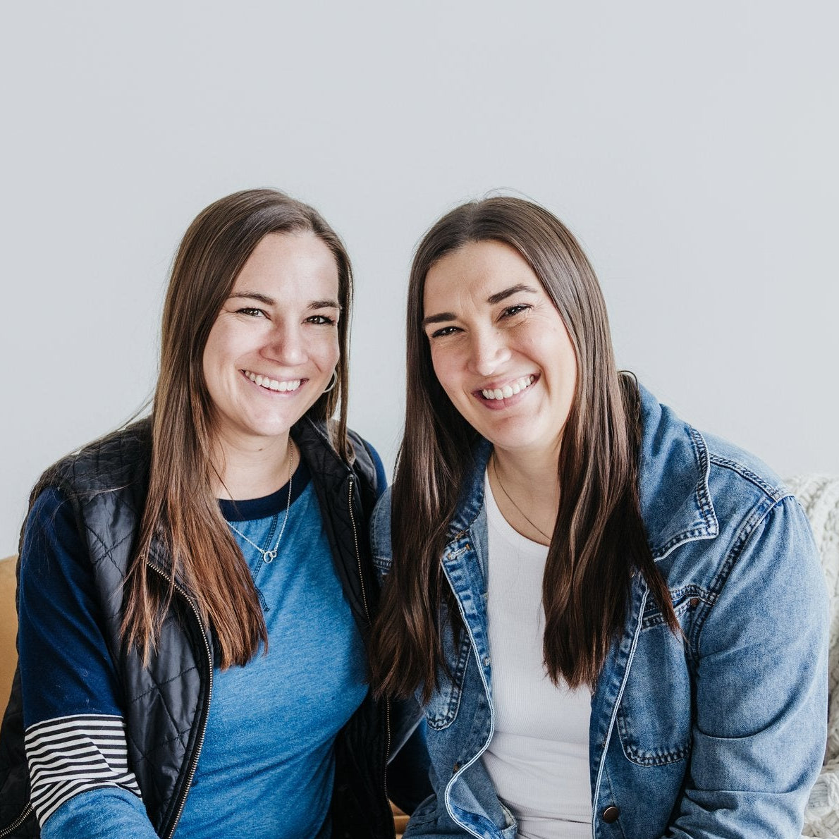 Lindsey and Ashley Auch sitting on a couch