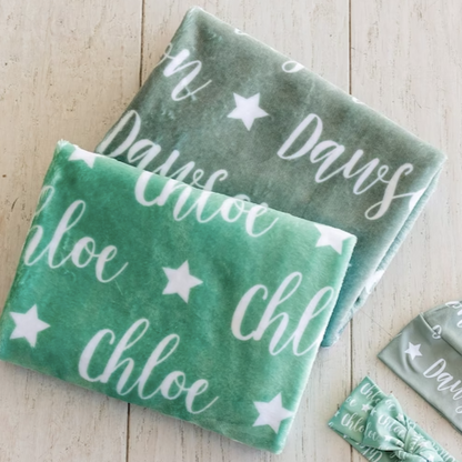 2 blankets, a hat, and a bow with the names chloe and dawson and a star icon