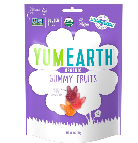 A package of YumEarth Organic Gummy Fruits with shapes resembling Easter bunny heads, displayed against a purple background.